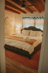 a bedroom with a bed with two towels on it at Casa Charleston-3BR-2Bath-HOT TUB-Pet Friendly-No Pet Fees! in Albuquerque