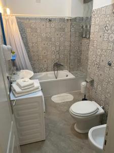 a bathroom with a toilet and a tub and a sink at Casa Major in Maiori +22 photos