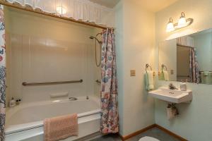 a bathroom with a bath tub and a sink at Turtle Rocks Oceanfront Inn in Trinidad