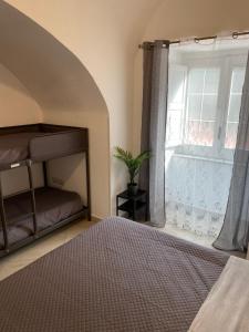 a bedroom with a bunk bed and a window at Casa Major in Maiori