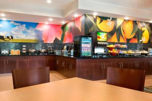 a bar in a restaurant with a table and chairs at Fairfield Inn & Suites Minneapolis-St. Paul Airport in Mendota Heights