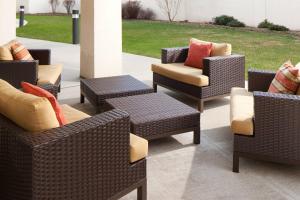 a group of wicker chairs and tables on a patio at Courtyard by Marriott Lebanon in Lebanon