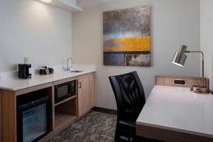 a room with a kitchen with a table and a microwave at SpringHill Suites by Marriott New Orleans Warehouse Arts District in New Orleans