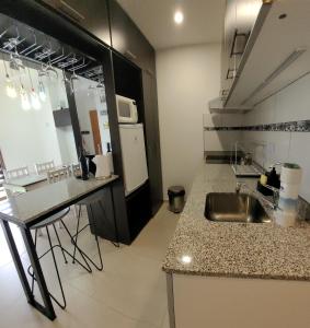a kitchen with a sink and a counter top at Comfortable apartment and excellent location in Ushuaia