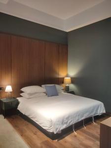una camera da letto con un grande letto bianco e pareti in legno di 木木宿宿MUMUsusu-stay只接待成年者一無包棟服務 a Città di Taitung Altre 37 foto