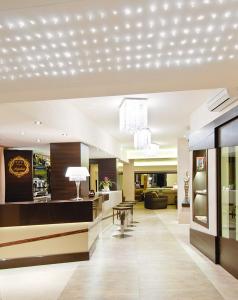 a living room with a lobby with a table at Hotel Argentina in Senigallia