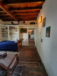 a bedroom with a bed and a wooden ceiling at Turiya niwas Kasar Devi in Almora