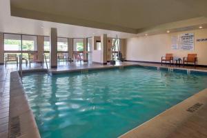 a large pool with blue water in a building at Courtyard by Marriott Princeton in Princeton