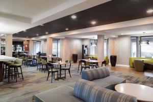 a hotel lobby with tables and chairs and a bar at Courtyard by Marriott Princeton in Princeton