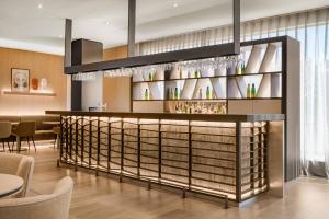 a wine bar in a restaurant with tables and chairs at AC Hotel Tarragona by Marriott in Tarragona