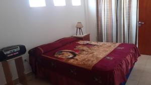 a bedroom with a bed with a picture of a woman at Departamento por día in Palpalá