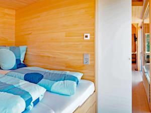 a bedroom with two beds and a wooden wall at Eco-friendly detached tiny house in the Black Forest on huge property 