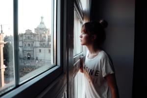 a woman looking out of a window at a building at Zócalo Central in Mexico City