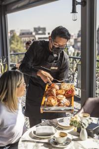 a man preparing a tray of pastries on a table at Zócalo Central in Mexico City +93 photos