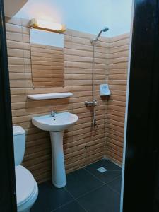 a bathroom with a sink and a toilet at Globe-trotter vision B in Cotonou