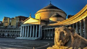 un edificio con una estatua de león delante de él en Latt e Liett en Nápoles