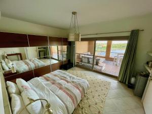 a large bedroom with two beds and a balcony at The Penthouse in Marassi in El Alamein