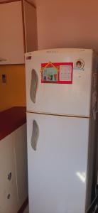 a white refrigerator with a sticker on the top of it at Sophenia in Agrelo