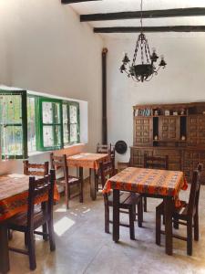 a dining room with tables and chairs and a chandelier at Inti Raymi in Maimará