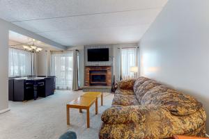 a living room with a couch and a fireplace at Mountain Village 5H Unit A in Dover