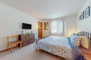 a bedroom with a bed and a tv and a dresser at Mountain Village 5H Unit B in Dover