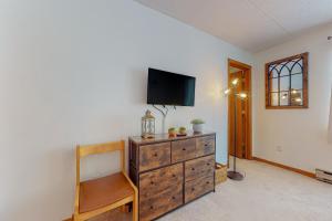 a living room with a dresser with a tv on it at Mountain Village 5H Unit B in Dover