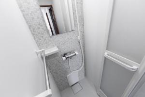a bathroom with a shower and a mirror at THE SUN in Sapporo +37 photos