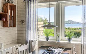 a kitchen with a window with a view of the ocean at 2 Bedroom Lovely Apartment In Lysekil in Lysekil