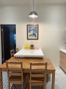 a kitchen with a wooden table and chairs at 大鳥240 號Guesthouse in Dawu