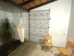 a porch with a swing and a chair at Departamento Frente a la Plaza Principal Jala in Jala