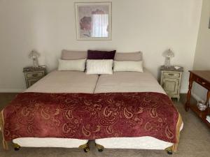 a large bed in a bedroom with two night stands at Rosewood Park Guest Suite in Yarragon