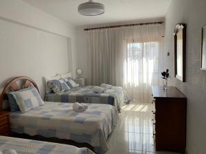 Postel nebo postele na pokoji v ubytování Apartamento aconchegante, Portimão Praia da Rocha