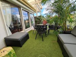 a screened in porch with a table and chairs at Vista Unit + Bamboo House Close to the City & Airport & Train station and Brighton Le Sands Beach in Sydney