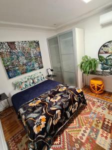 a bedroom with a bed with a comforter and a rug at Vista Unit + Bamboo House Close to the City & Airport & Train station and Brighton Le Sands Beach in Sydney