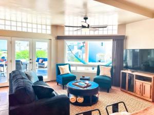 a living room with a couch and chairs and a tv at Sandy Beach Costa Diamante House E10 Dog Friendly in Puerto Peñasco