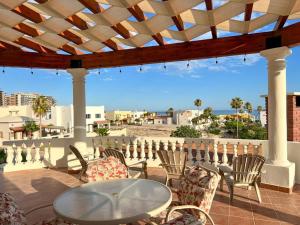 a table and chairs on a patio with a view of the ocean at Sandy Beach Costa Diamante House E10 Dog Friendly in Puerto Peñasco