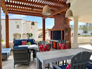 a patio with a table and chairs and a fireplace at Sandy Beach Costa Diamante House E10 Dog Friendly in Puerto Peñasco
