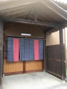 a building with two flags hanging on a wall at MOMO HOUSE in Inami