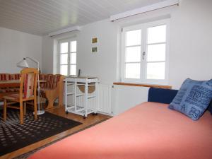 a living room with a bed and a table at Apartment in Schultenbrook with garden in Metelsdorf