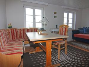 a living room with a wooden table and chairs at Apartment in Schultenbrook with garden in Metelsdorf