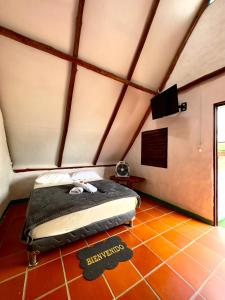 a bedroom with a bed in a attic at Hotel La Reserva in San Gil