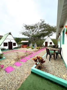 a patio with a table and chairs and tents at Hotel La Reserva in San Gil