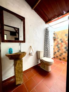 a bathroom with a sink and a toilet at Hotel La Reserva in San Gil