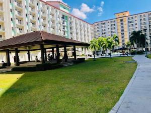 a gazebo in a park in front of a building at Field Residence SMDC 1BR w/ Netflix in Manila