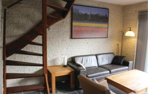 a living room with a couch and a loft bed at Two-Bedroom Holiday Home In Callantsoog in Callantsoog