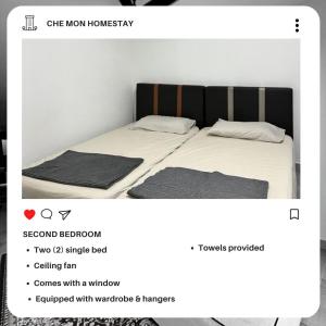 a screenshot of a bedroom with two beds at CHE MON Homestay in Kuching