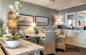 a kitchen and dining room with a table and chairs at Beach Front Apartment In Cadzand-bad With Kitchen in Cadzand-Bad