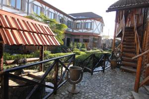 a courtyard with a building with a staircase and a house at Khan Lankaran Hotel in Lankaran