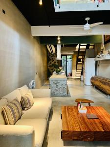 a living room with a couch and a wooden table at 隱室x迷路 Hermit Inn Hengchun in Hengchun