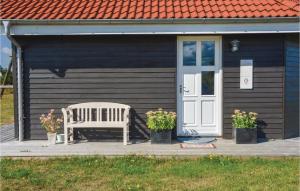 a white bench sitting in front of a house at Holiday Home Syrenvej Skjern Ix in Skjern